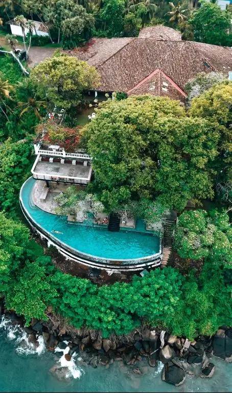 Aerial view of the cliffside pool curving around the Closenberg Hotel estate
